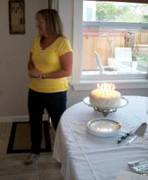 Trish and her birthday cake (the candles are burning)